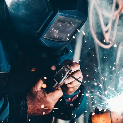 Welder at work with bright sparks