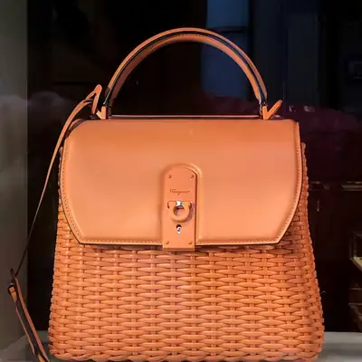 Tan leather handbag with a woven body