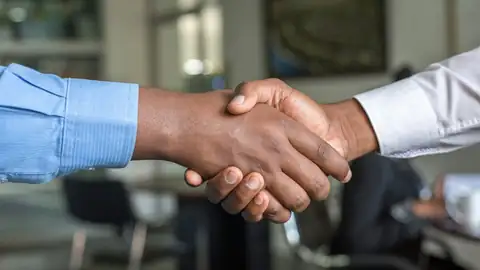 Two business partners shaking hands on a deal