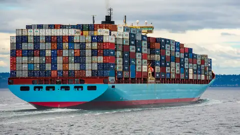 Container ship loaded with colourful containers at sea